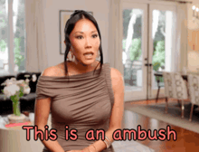 a woman in a brown dress says this is an ambush in a living room