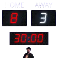 a man stands in front of a scoreboard that reads home 3 away