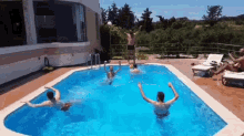 a group of people are swimming in a pool