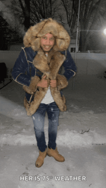 a man wearing a fur coat and hat standing in the snow with the caption " her is 75 weather "