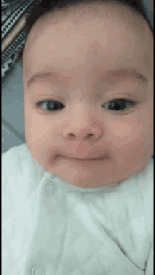 a close up of a baby 's face with a smiley face