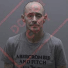 a man wearing a grey abercrombie and fitch t-shirt