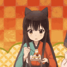 a girl with cat ears is holding a piece of cake in her hands .