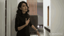 a woman is standing in a hallway with the words made in animatica behind her