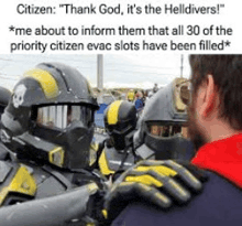 a man in a red shirt is talking to a group of firefighters in armor .