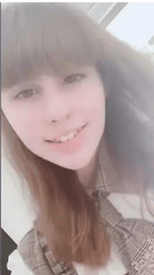 a close up of a woman 's face with a blurred background .