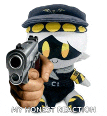 a person is pointing a gun at a stuffed animal with a hat on .