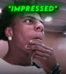 a man with his hand on his chin and the words impressed above him