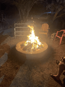 a fire pit is lit up at night in a yard