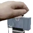 a close up of a person 's hand holding a block .