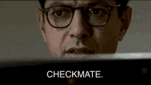 a close up of a man wearing glasses and the words checkmate