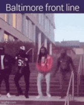 a group of people are standing on stairs in front of a building .