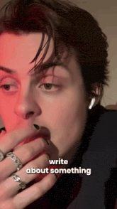 a close up of a person 's face with the words " write about something " on the bottom