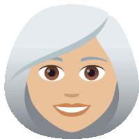 a woman with gray hair and brown eyes smiles for the camera