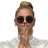 a woman wearing sunglasses is praying with her hands together .