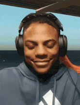 a man wearing headphones and a blue adidas hoodie