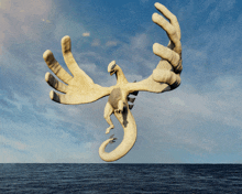 a statue of a white dragon flying over the ocean