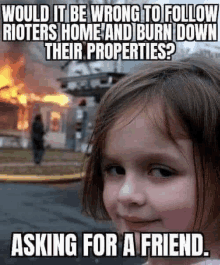 a little girl is smiling in front of a burning house .