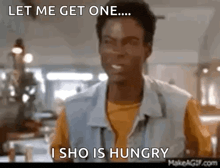 a man is standing in a restaurant and saying let me get one ... i sho is hungry