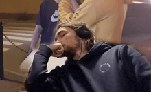 a man wearing headphones and a sweatshirt that says ' dont panic ' on it