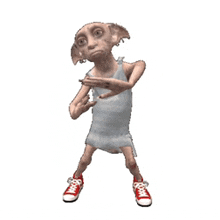 a dobby from harry potter is dancing in a white dress and red sneakers