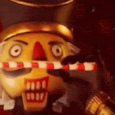 a close up of a nutcracker holding a gun and candy cane .