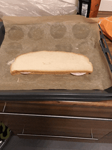 a loaf of bread with ham on it is on a pan