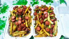 two styrofoam containers of french fries and sausages