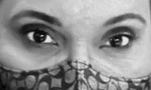 a black and white painting of a woman 's eyes with a mask on her face .