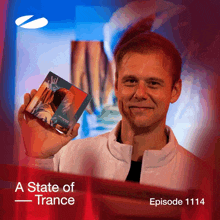 a man holding a cd with the words a state of trance episode 1114 on the bottom