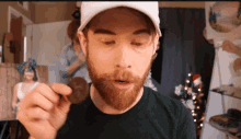 a man with a beard is holding a piece of chocolate
