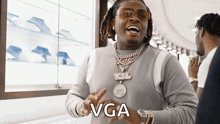 a man wearing sunglasses and a sweater with the word vga written on it