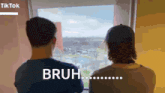 two men looking out a window with the words bruh on the bottom right