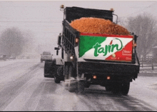 a tajin truck is driving through the snow