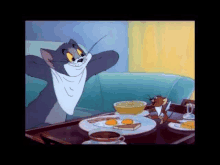 tom and jerry are sitting at a table with a tray of food and a cup of coffee .