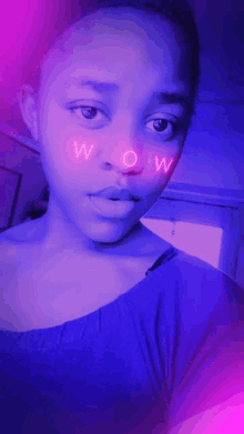 a woman 's face with the word wow written on it