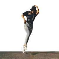 a woman wearing adidas shoes is dancing on the street