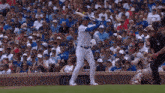 a baseball player swings his bat in front of a crowd wearing a jersey that says ' chicago ' on it