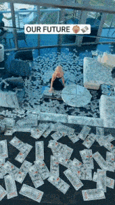 a woman sits on a couch surrounded by hundred dollar bills and a sign that says our future