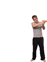 a man is holding an orange toy gun in his hand