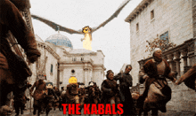 a group of people walking down a street with the words the kabals written on the bottom