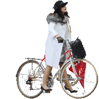 a woman in a white coat is riding a bicycle with a red umbrella