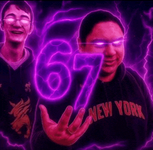 a man wearing a new york hoodie is holding a purple number 67 in his hand .