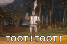 a wizard of oz character is standing in the woods with the words toot ! toot ! above him .