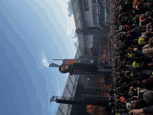 a crowd of people watching a concert at a stadium with a sign that says ' a & r ' on it