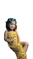 a little girl wearing a yellow floral dress and sunglasses