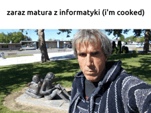 a man taking a selfie in front of a statue that says zaraz matura z informatyki ( i 'm cooked