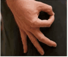 a close up of a person 's hand making a ok sign with their fingers .