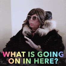 a woman in a fur coat with the words what is going on in here on the bottom