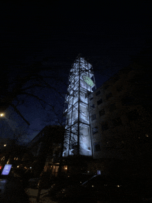 a tall building with stairs going up to the top at night